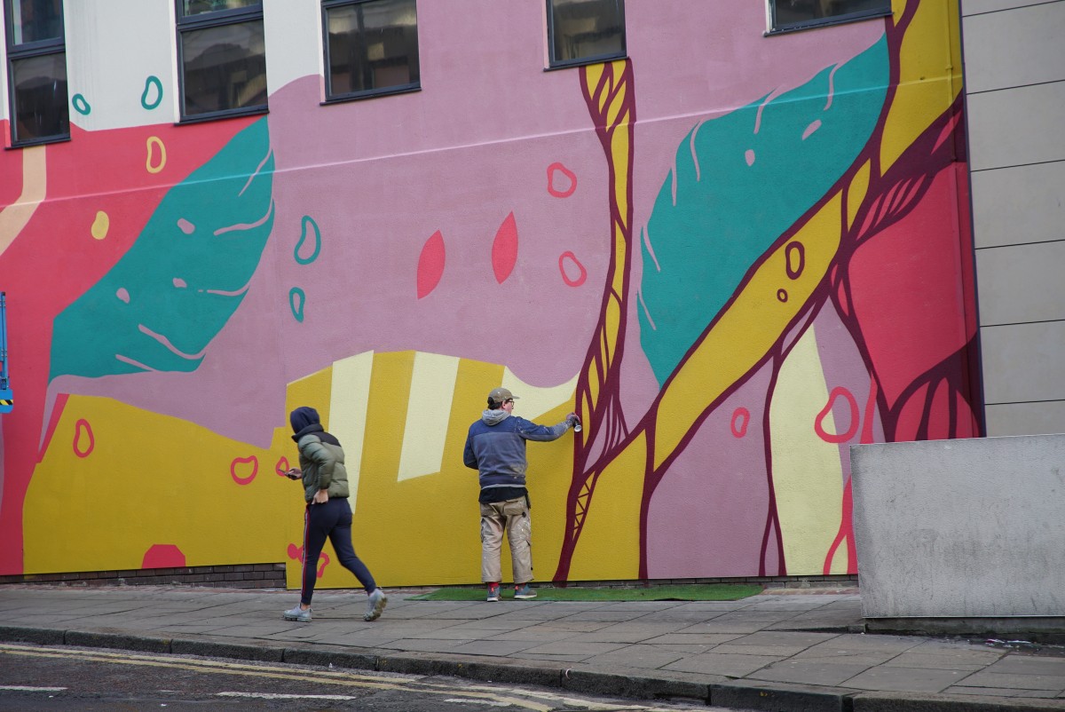 Bobzilla at work on his mural on Groat Market